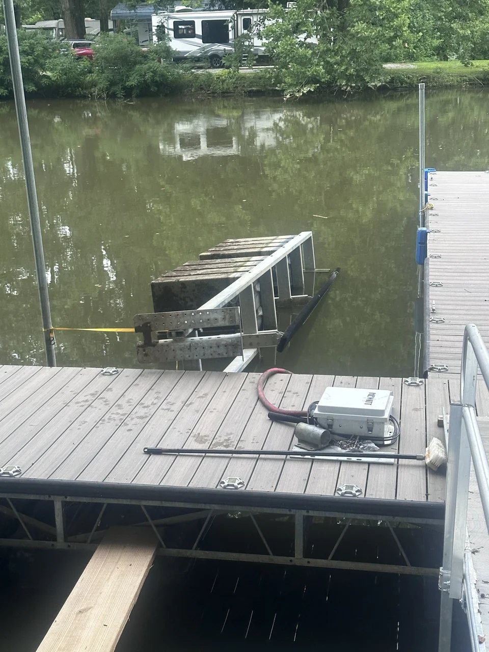 Small boat next to a wooden dock on calm water