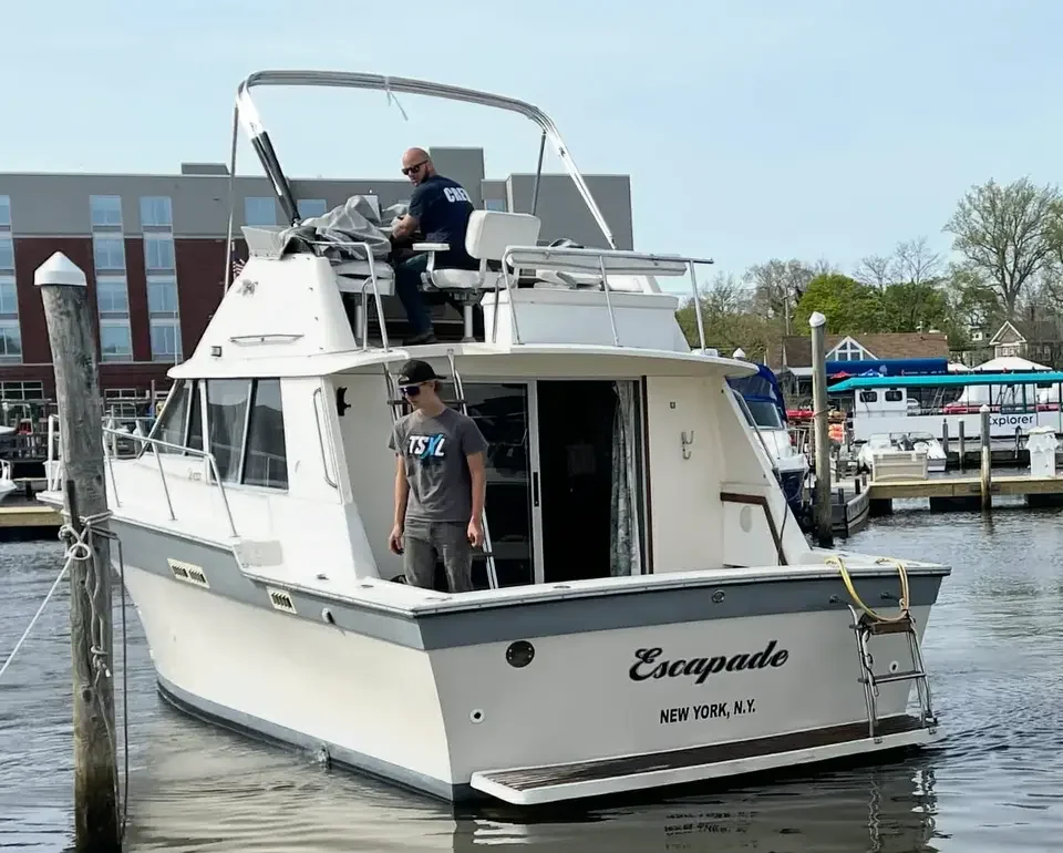Stern of a white cabin cruiser at a marina dock
