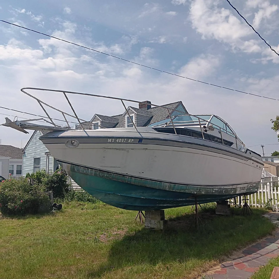 White cruiser with a green lower hull supported on land